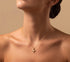 RITI delicate gold ballerina necklace with a fan-shaped skirt and intricate engravings. Minimalist pendant.