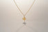 RITI delicate gold ballerina necklace with a fan-shaped skirt and intricate engravings. Minimalist pendant.