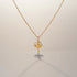 RITI delicate gold ballerina necklace with a fan-shaped skirt and intricate engravings. Minimalist pendant.