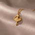 RITI gold-tone ballerina pendant necklace with delicate fan-shaped skirt and fine chain. Minimalist jewelry.