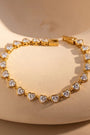 RITI gold tennis bracelet featuring heart-cut cubic zirconia stones in a bezel setting for a romantic, elegant look.