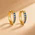 זוג חישוקים משובצים בגוון זהב עם זירקונים כחולים